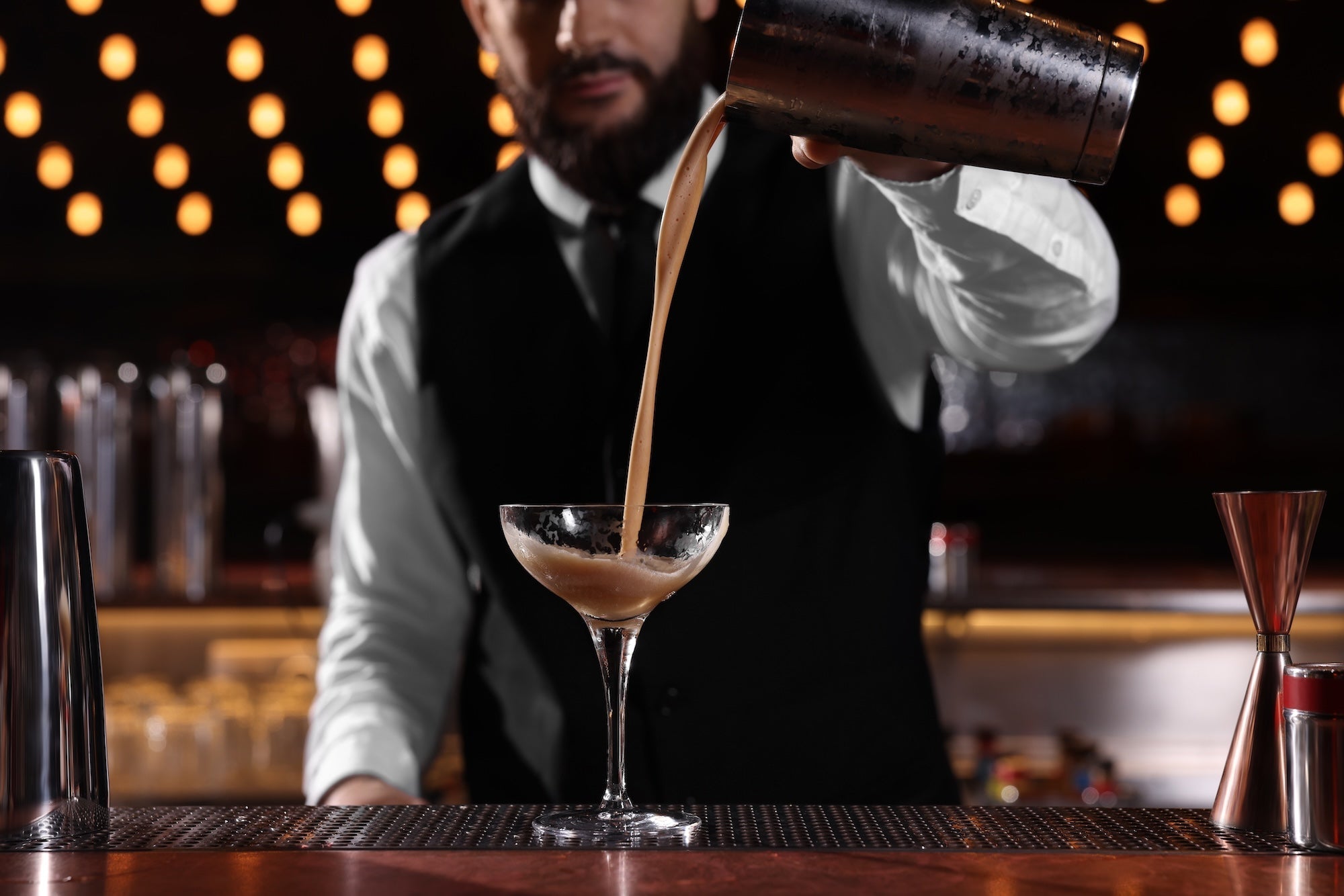 Bartender pouring an espresso martini from shaker