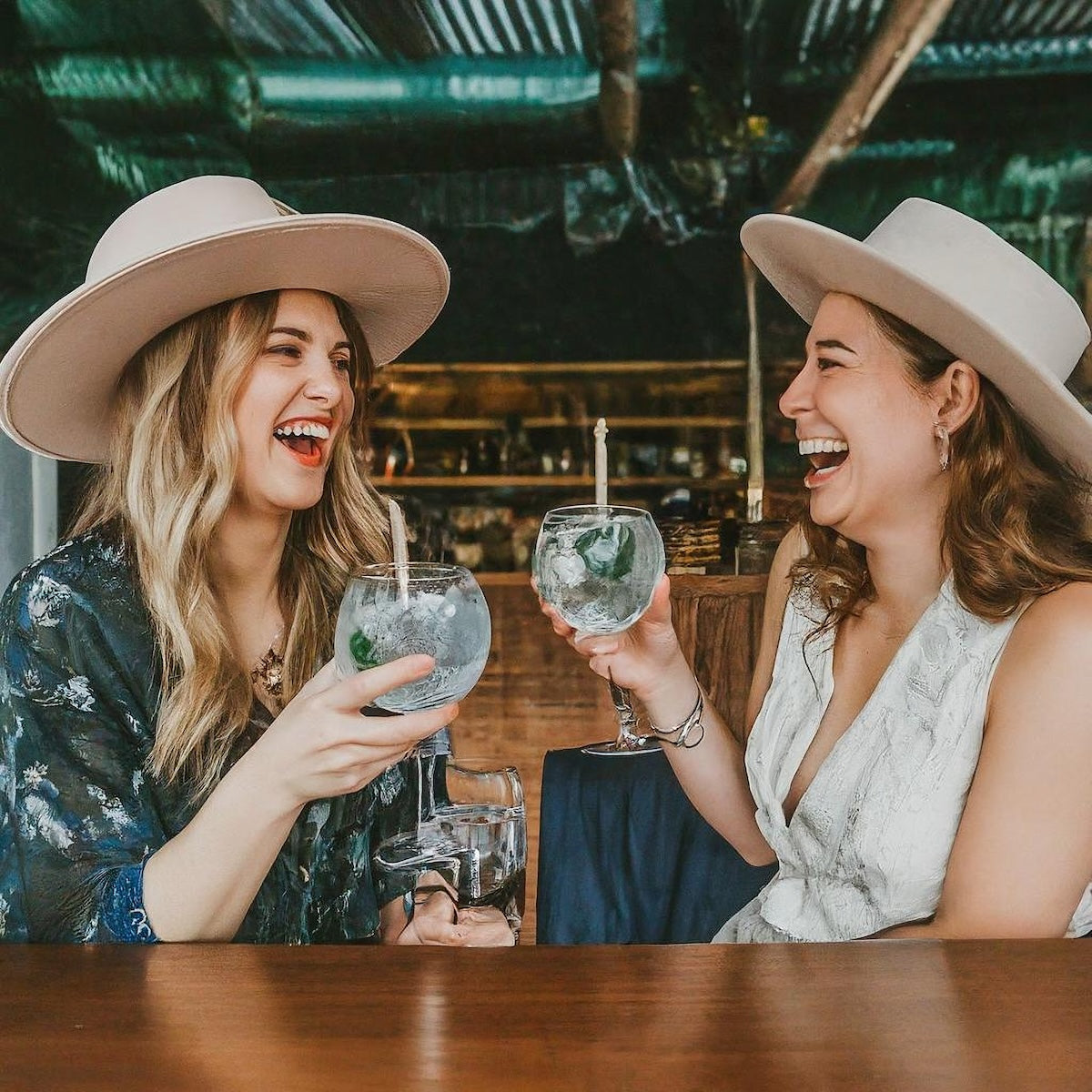 Cool ladies drinking tonic with hats, square crop, small size